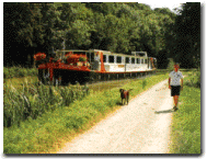 The luxury barge cruies along the beautiful waterways