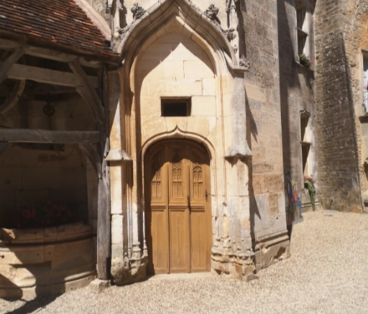 An old entrance to the tower beside the water well